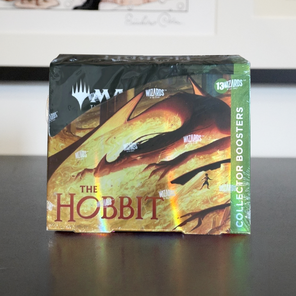 A sealed box of Magic: The Gathering: The Hobbit collector boosters, featuring artwork of a dragon and the title 'The Hobbit'