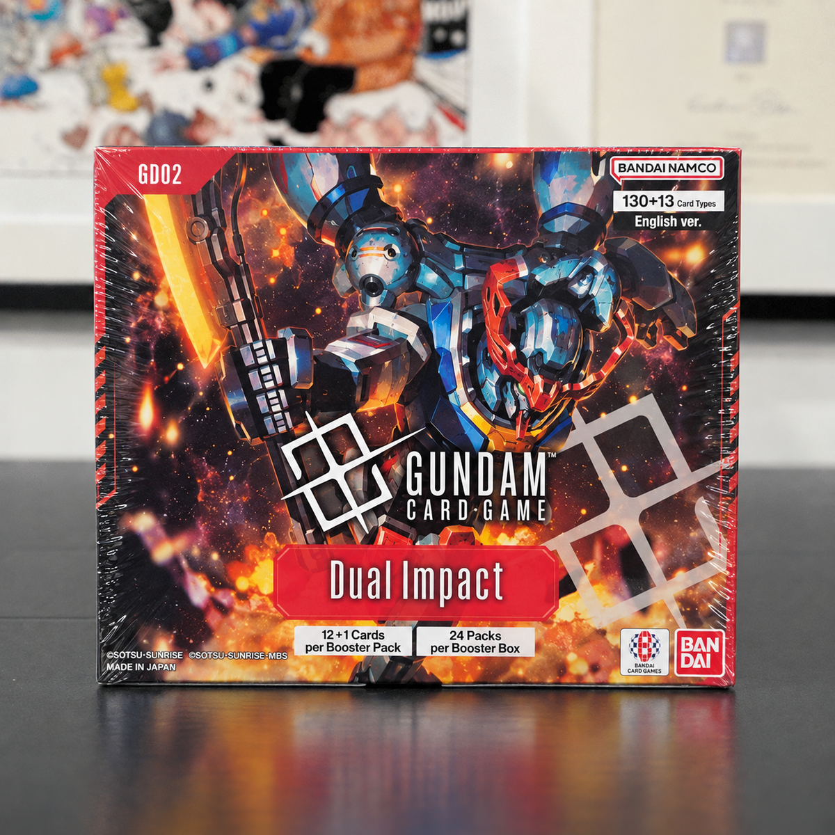 A sealed box of Bandai Namco Gundam Card Game Dual Impact English ver., model G6002, featuring a highly detailed sci-fi mecha illustration on the front.