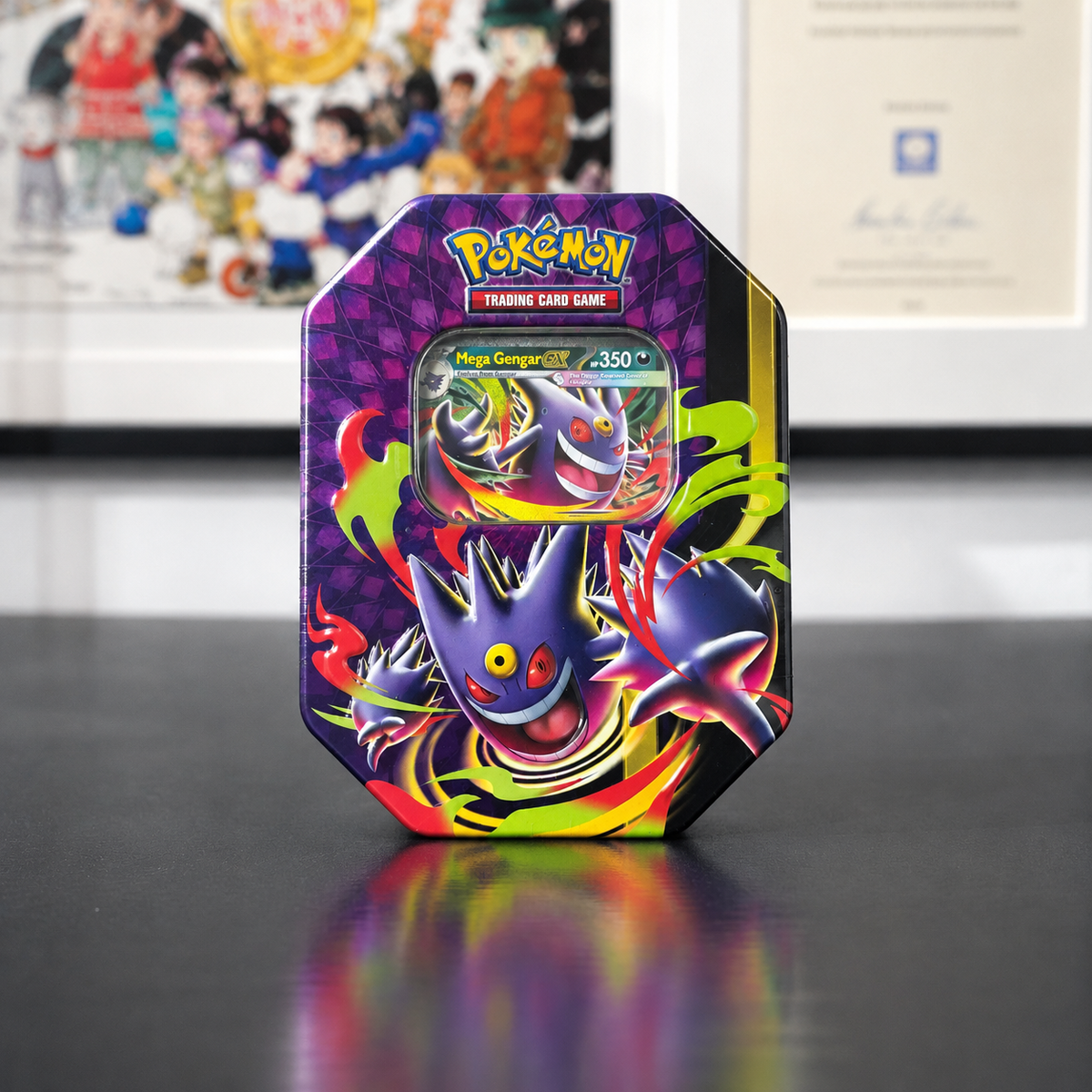 A Pokémon Trading Card Game booster tin featuring Mega Gengar artwork